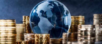 Globe and stack with coins. Money makes the world go round